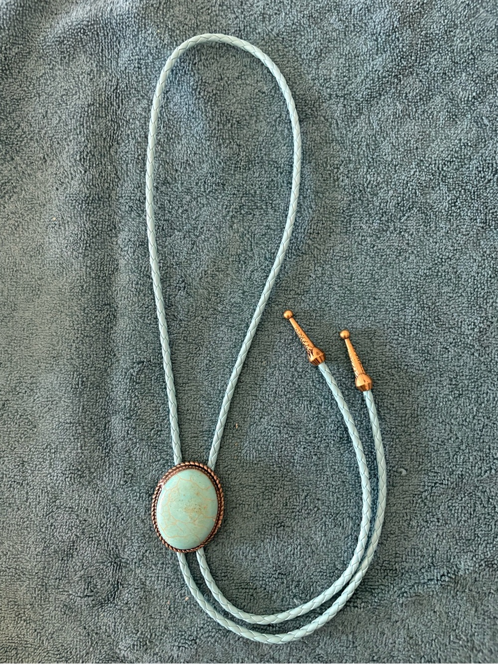 Light Blue Braided Bolo Tie with Gold-Tone Accents and Oval Stone